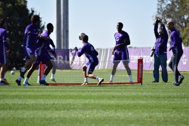 Players participate in soccer tennis to warm up during training prior to Orlando City SC's media day on Friday, February 26, 2016. (Victor Ng / Orlando Soccer Journal)